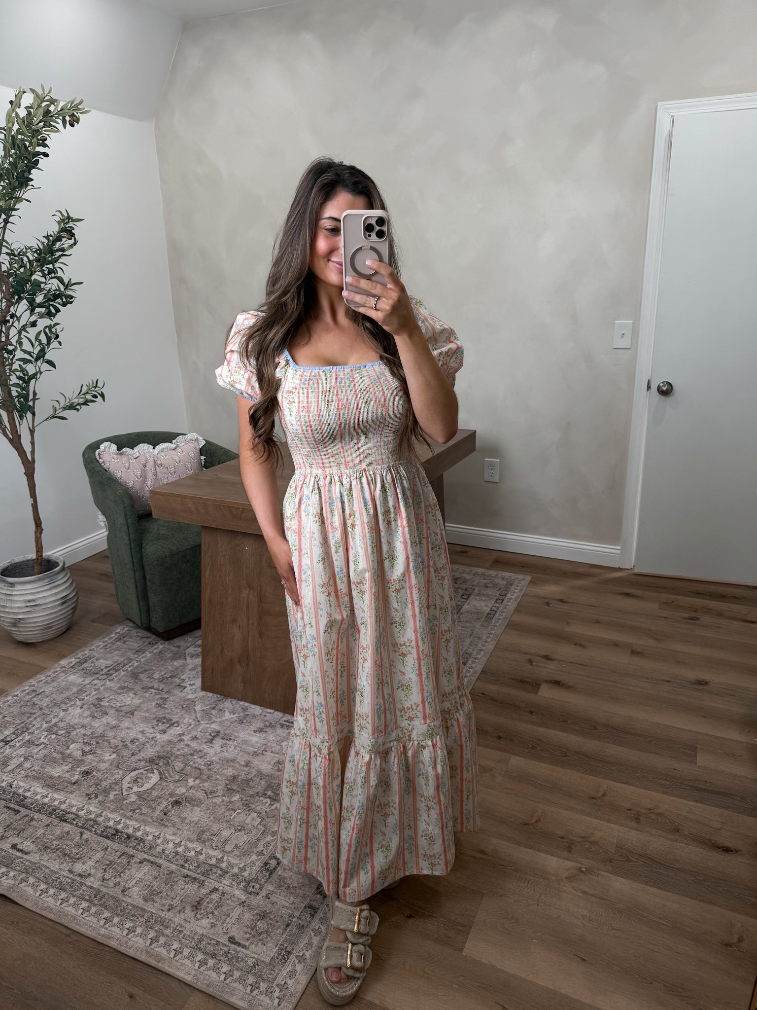 Pastel smocked maxi dress on a model in a room 