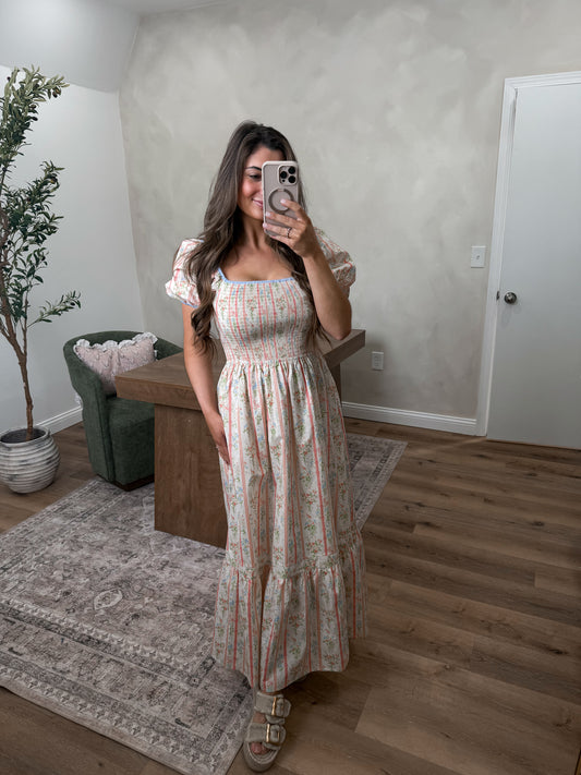 Pastel smocked maxi dress on a model in a room 
