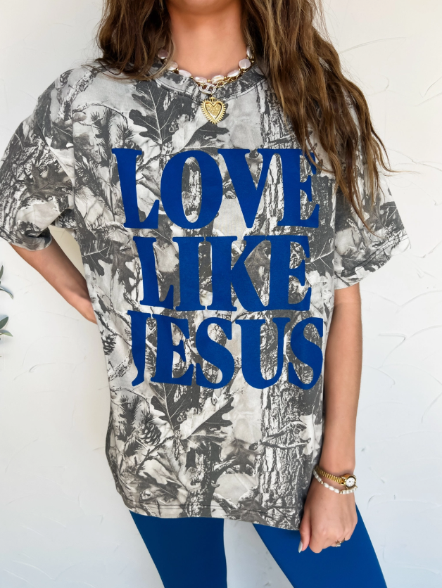 Person wearing a shirt with 'Love Like Jesus' text on a white background